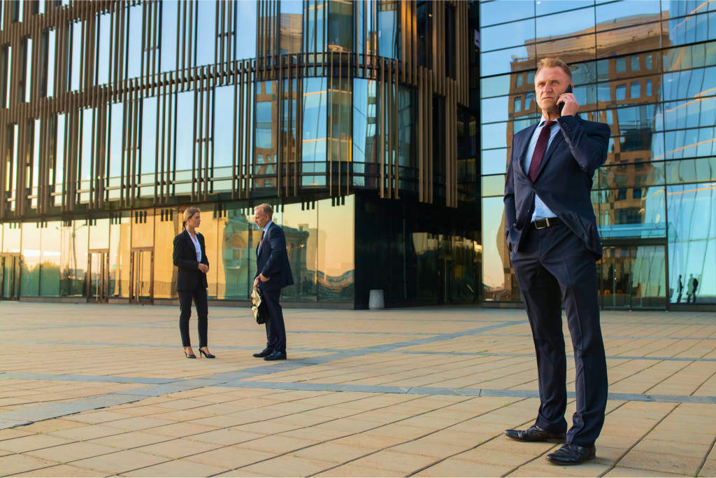 Bell Partners client on a call outside a modern office building