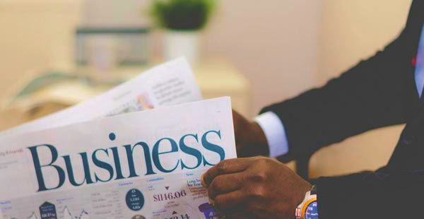 Reading the finance section of a newspaper